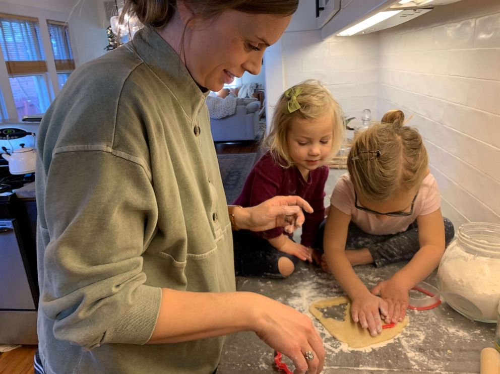 Mansfield is pictured baking with two of her daughters.