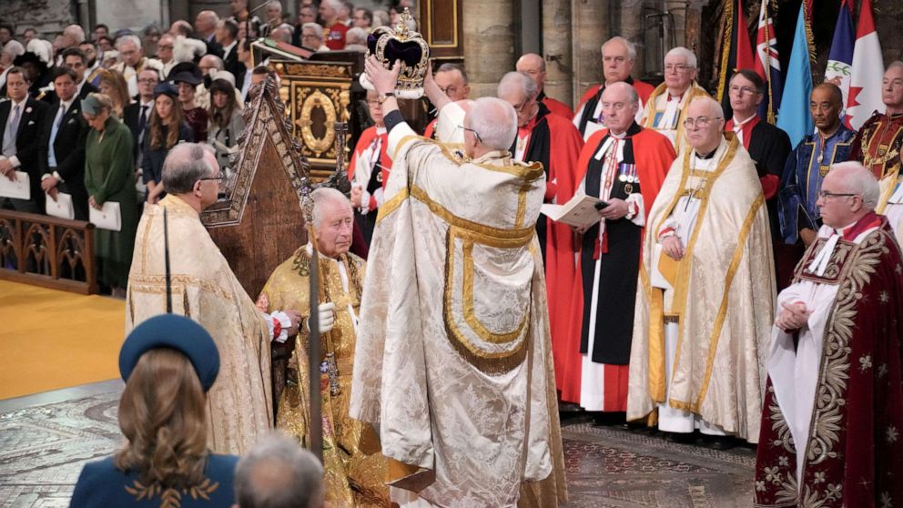 King Charles III sits as he receives The St Edward's Crown during the coronation ceremony at Westminster Abbey, in London, May 6, 2023.
