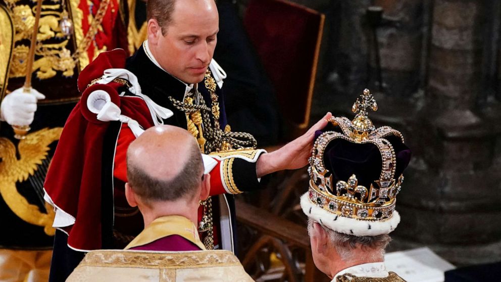 The Prince of Wales touches St Edward's Crown on King Charles III's head during his coronation ceremony in Westminster Abbey, London, May 6, 2023.