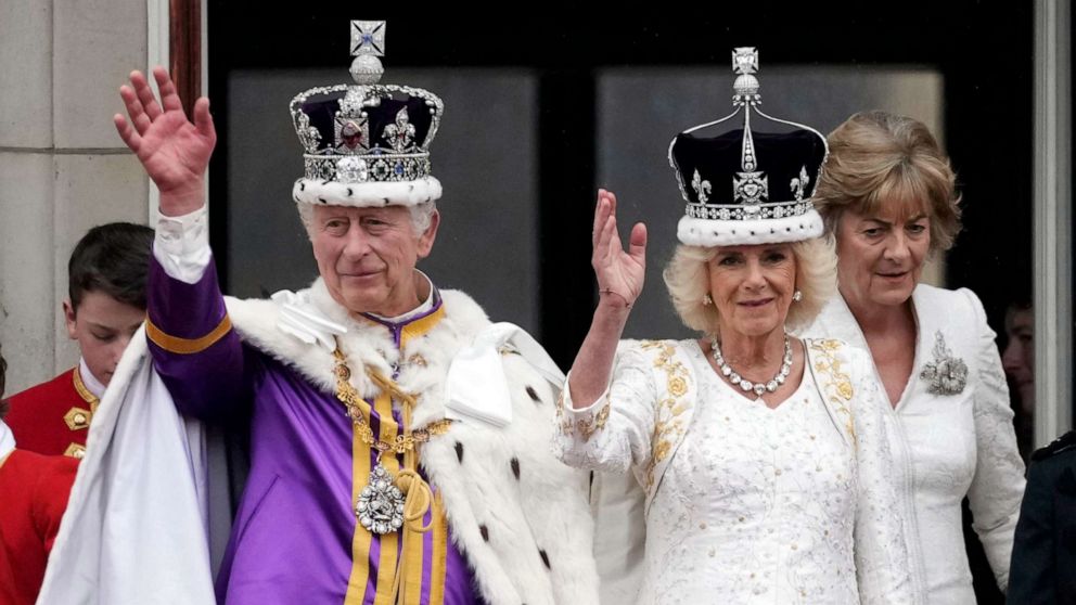 King Charles III and Queen Camilla can be seen on the Buckingham Palace balcony ahead of the flypast during the Coronation of King Charles III and Queen Camilla, May 06, 2023 in London.