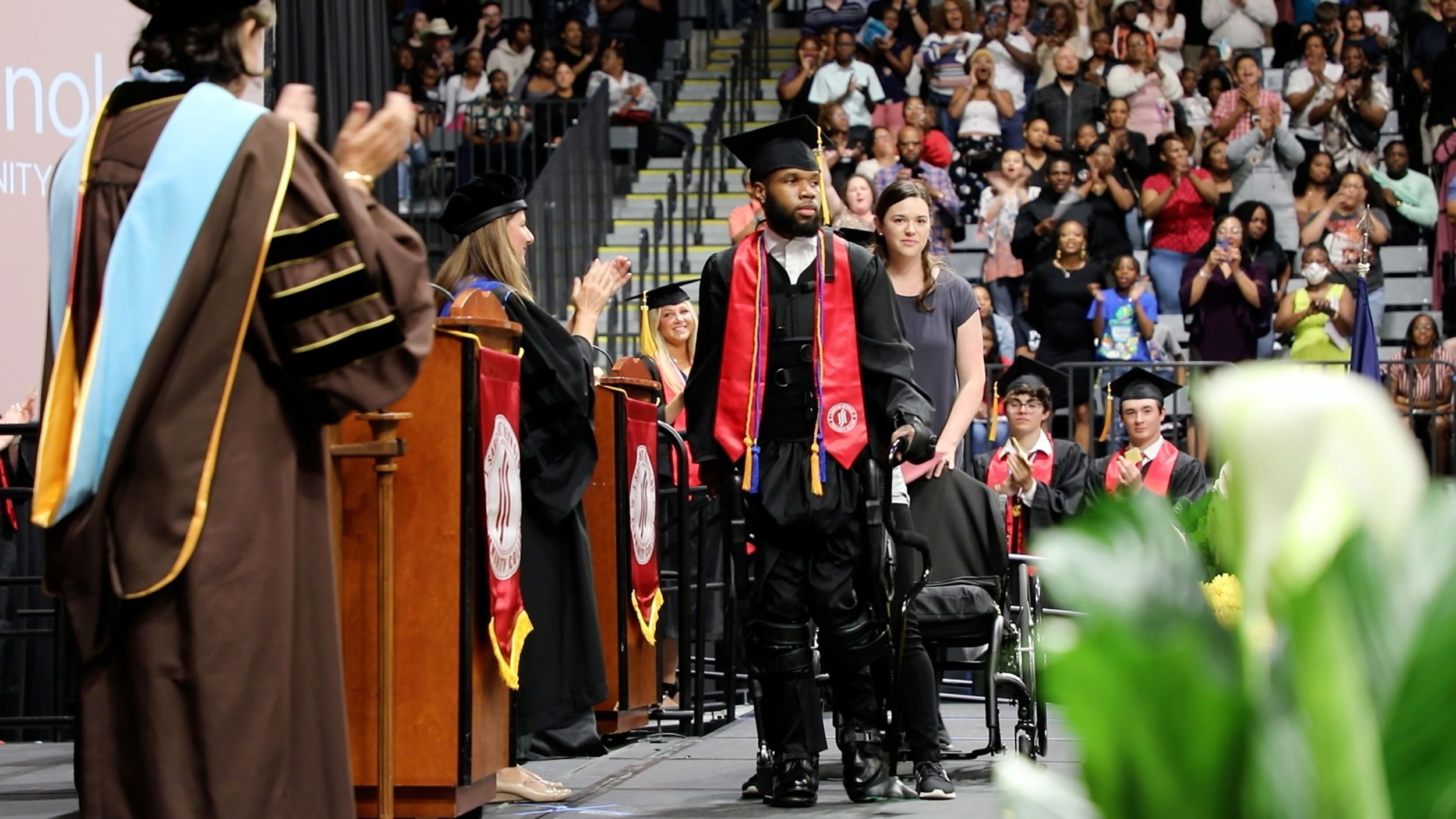 Student walks across graduation stage after shooting left him paralyzed