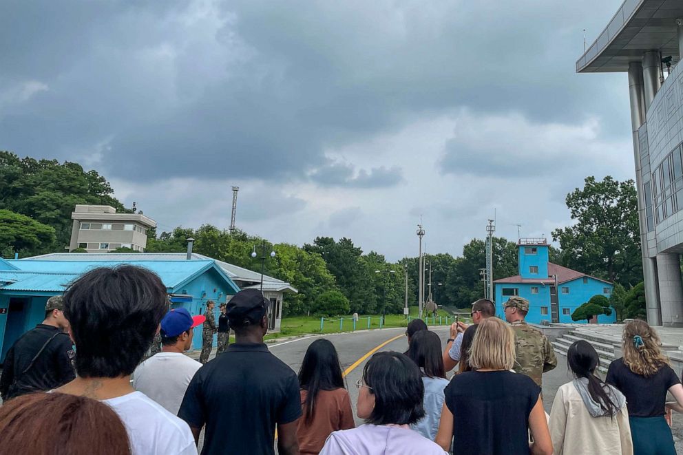 A group of tourists stand near a border station at Panmunjom in the Demilitarized Zone in Paju, South Korea, July 18, 2023.