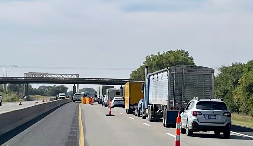 A long line of cars stuck in standstill traffic due to crash on Kansas Turnpike