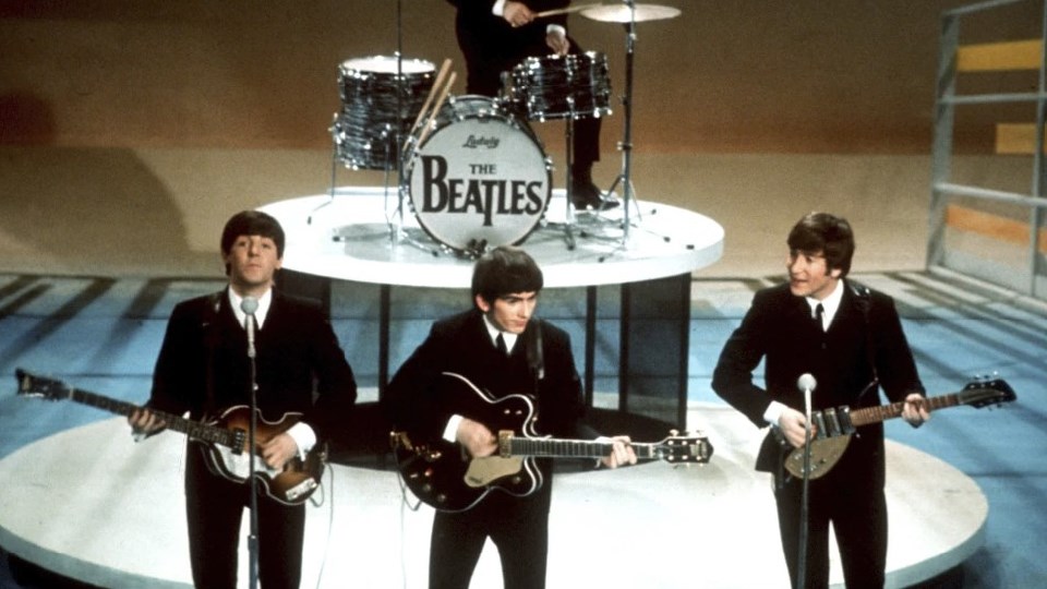 Woman mourns the death of former Beatles member, guitarist John